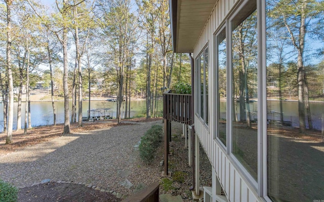 unfurnished sunroom featuring a water view