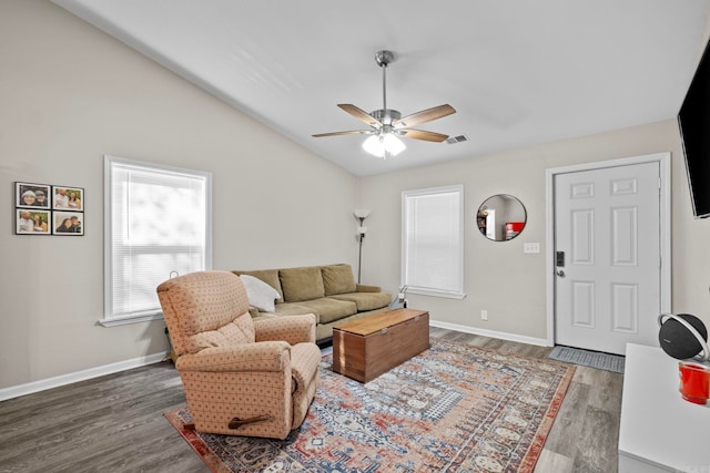 living room with lofted ceiling, ceiling fan, and dark hardwood / wood-style floors