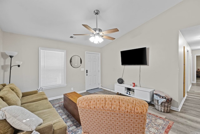 living room with ceiling fan, hardwood / wood-style floors, and lofted ceiling