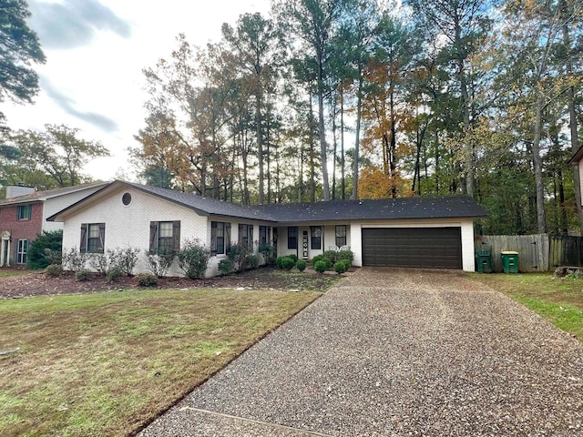 single story home with a front yard and a garage