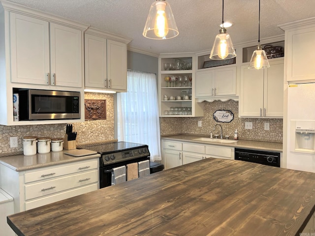 kitchen with ornamental molding, sink, black appliances, decorative light fixtures, and butcher block countertops