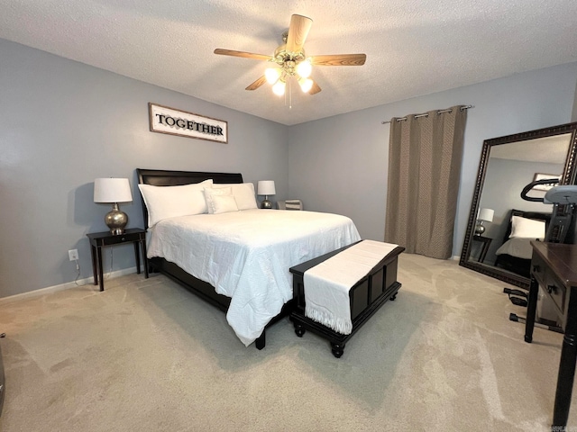 bedroom with light carpet, a textured ceiling, and ceiling fan