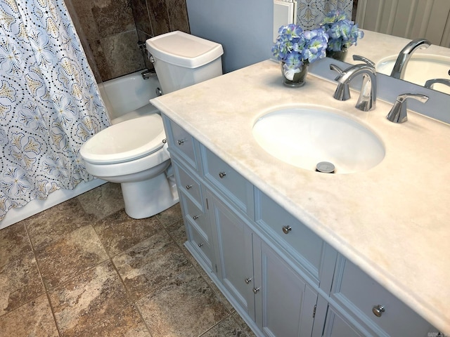 full bathroom with shower / tub combo, vanity, and toilet