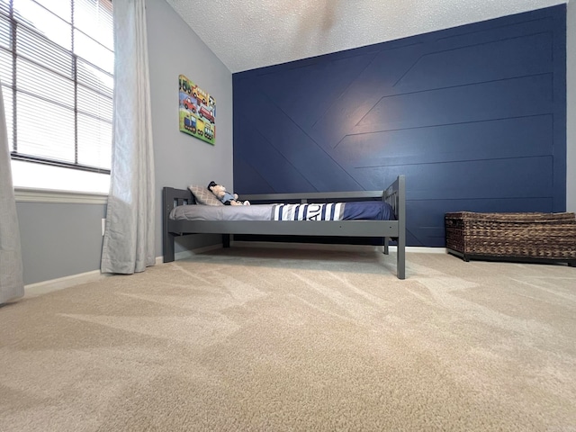 carpeted bedroom with a textured ceiling