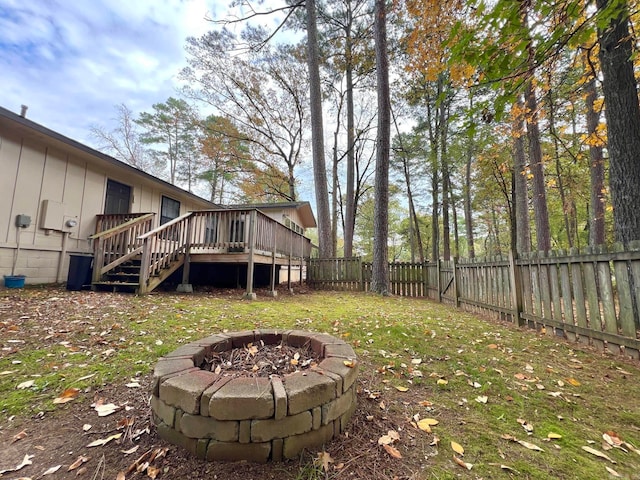 view of yard featuring a fire pit and a wooden deck