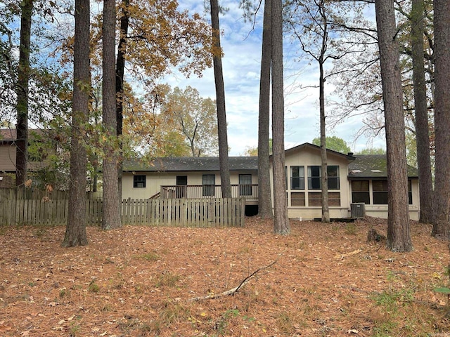 rear view of house featuring a wooden deck and central air condition unit