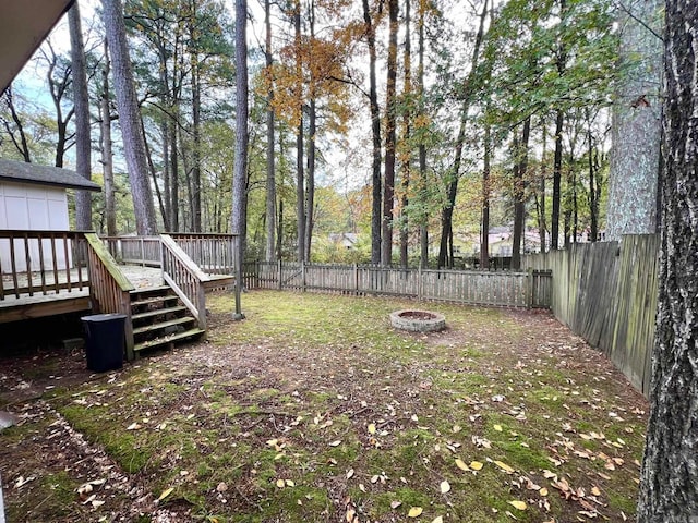 view of yard featuring an outdoor fire pit and a deck