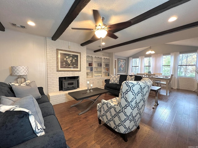 living room featuring beam ceiling, ceiling fan, dark hardwood / wood-style flooring, and a textured ceiling