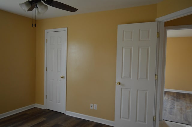 106 W Clinton, Heber Springs, AR 72543 - unfurnished bedroom with dark wood-style flooring, baseboards, and ceiling fan