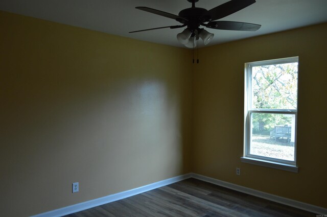 spare room featuring dark hardwood / wood-style flooring and ceiling fan