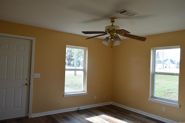 unfurnished room featuring ceiling fan and dark wood-type flooring