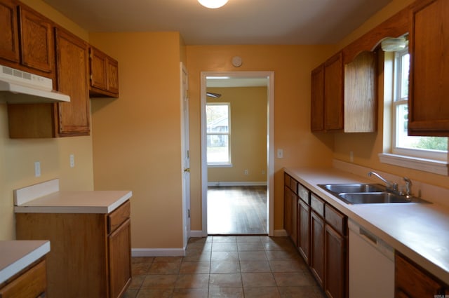 106 W Clinton, Heber Springs, AR 72543 - kitchen featuring dishwasher, under cabinet range hood, a sink, brown cabinets, and plenty of natural light