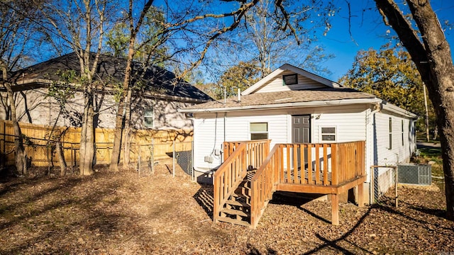 rear view of property featuring a deck