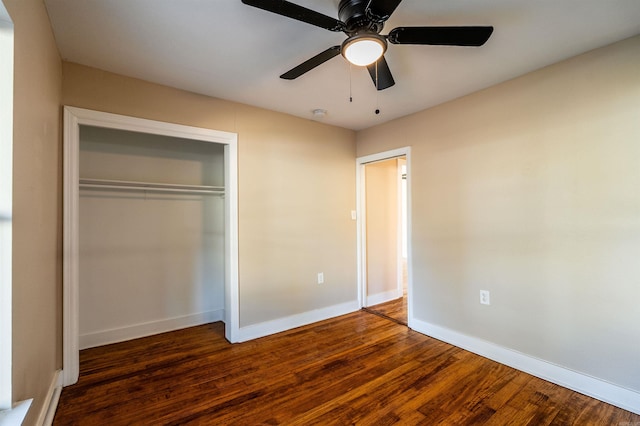 unfurnished bedroom featuring ceiling fan, dark hardwood / wood-style floors, and a closet