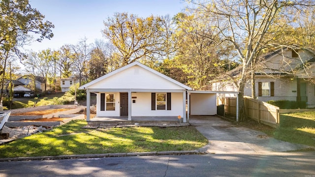 bungalow-style home featuring a front yard, a carport, and a porch