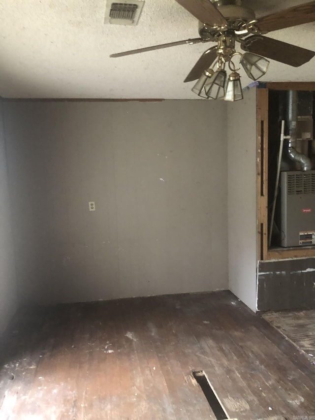 empty room with ceiling fan and dark hardwood / wood-style flooring