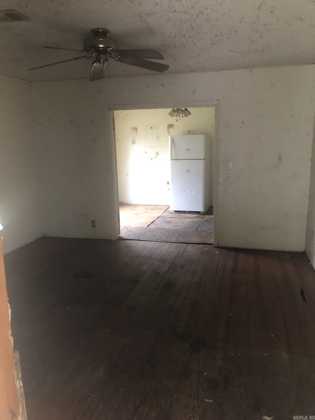 unfurnished room with ceiling fan and wood-type flooring