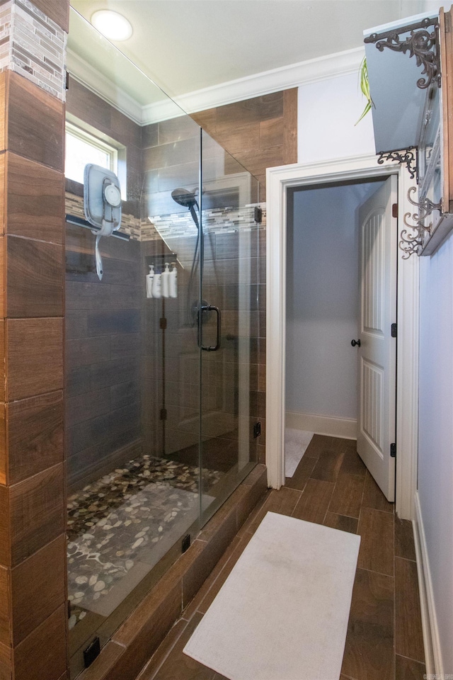 bathroom featuring an enclosed shower and crown molding