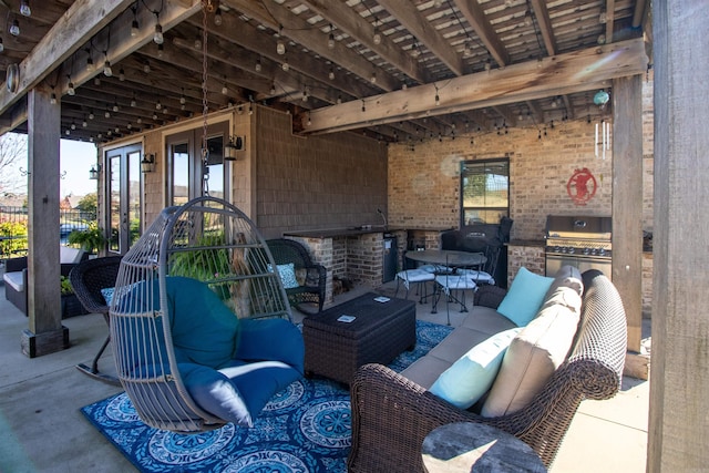 view of patio featuring outdoor lounge area, exterior kitchen, and grilling area