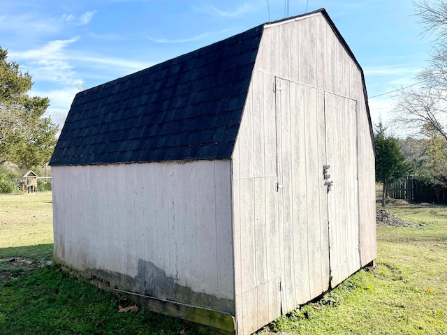 view of outbuilding with a yard