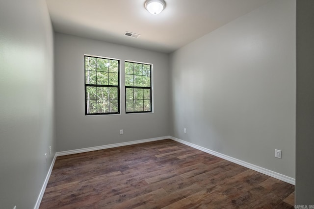 unfurnished room featuring dark hardwood / wood-style floors