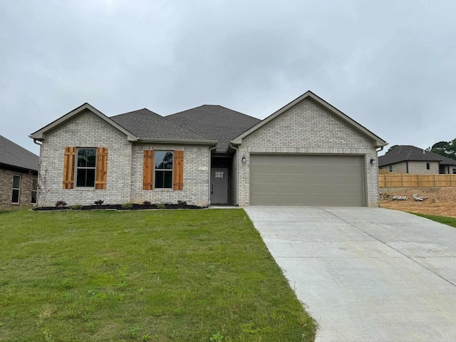 view of front of home with a garage and a front yard