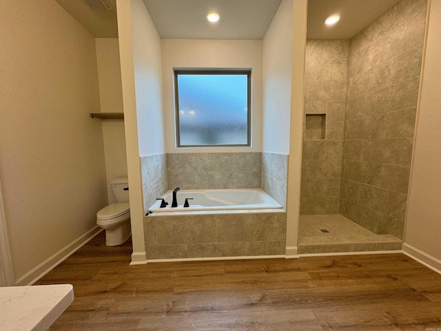 bathroom featuring toilet, wood-type flooring, and independent shower and bath