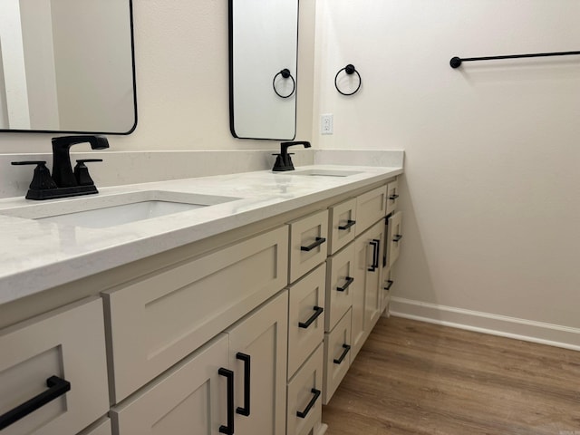 bathroom featuring hardwood / wood-style flooring and vanity