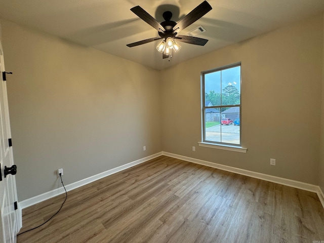 empty room with ceiling fan and light hardwood / wood-style flooring