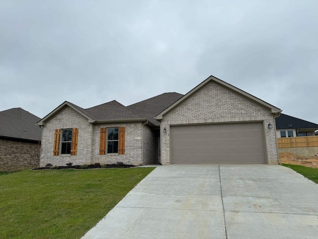 view of front of house with a garage and a front lawn