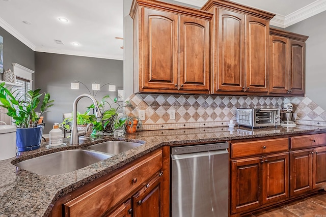 kitchen with backsplash, ornamental molding, sink, dark stone countertops, and dishwasher