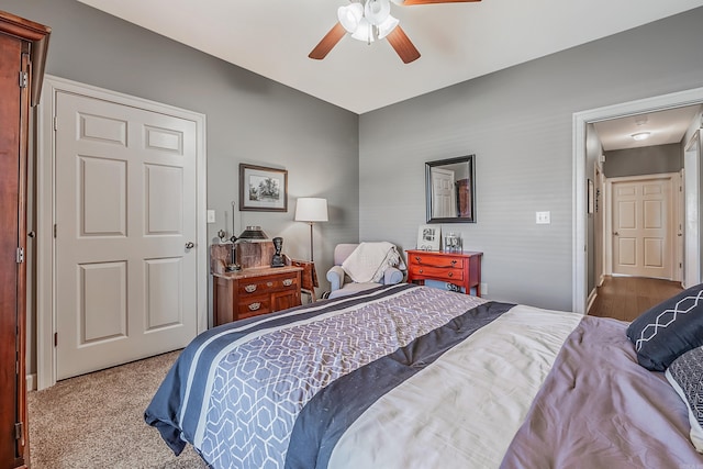 bedroom with ceiling fan and light colored carpet