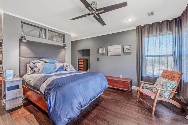 bedroom featuring ceiling fan, dark hardwood / wood-style flooring, and ornamental molding