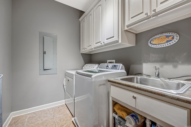 laundry area featuring cabinets, electric panel, sink, light tile patterned floors, and washing machine and clothes dryer