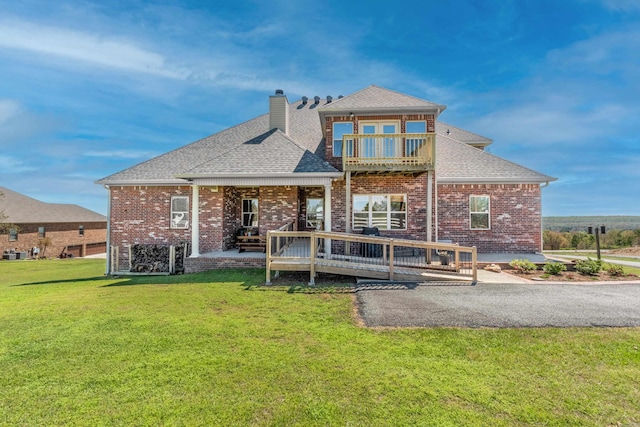 back of house with a yard, a balcony, and a patio