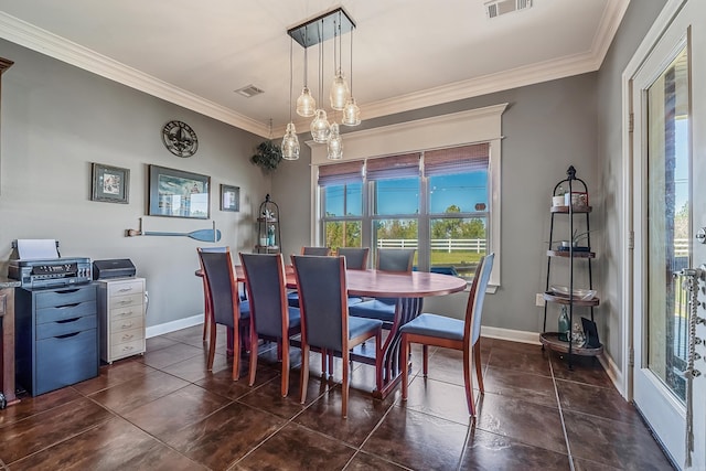 dining room with crown molding, a healthy amount of sunlight, and dark tile patterned flooring