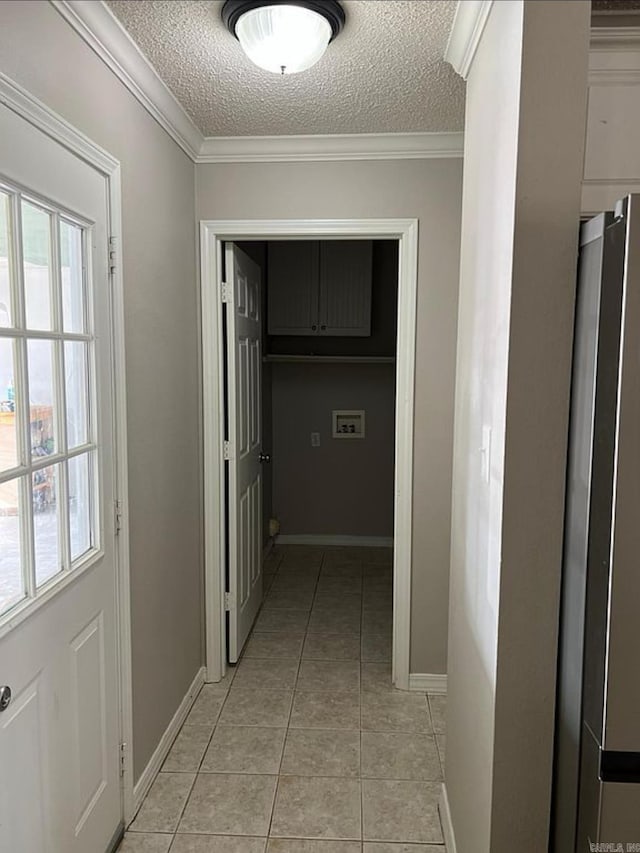 corridor with a textured ceiling, crown molding, and light tile patterned flooring