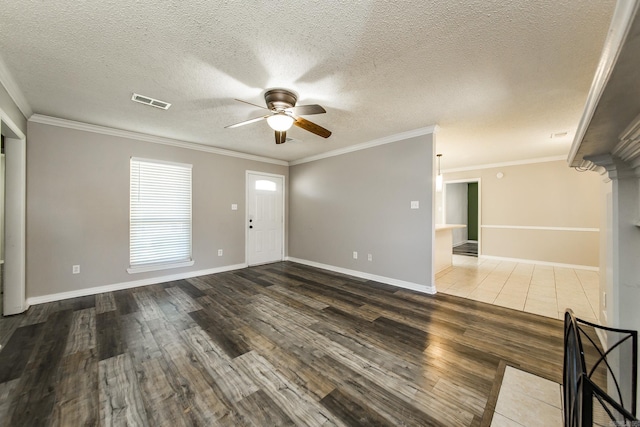 unfurnished room featuring ceiling fan, dark wood-type flooring, a textured ceiling, and ornamental molding