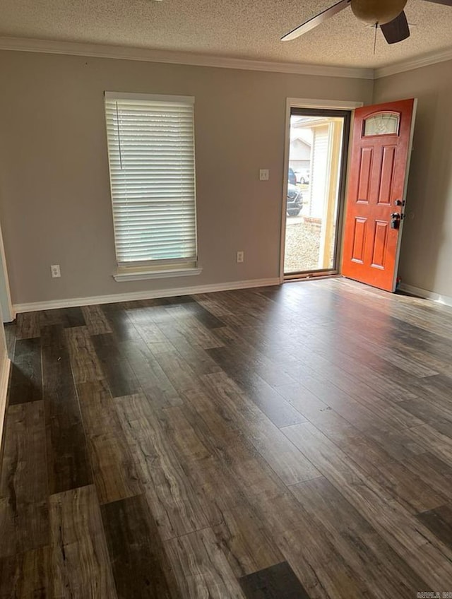 spare room featuring ceiling fan, dark hardwood / wood-style flooring, crown molding, and a textured ceiling