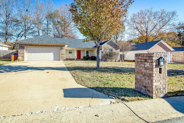 ranch-style home featuring a front lawn and a garage