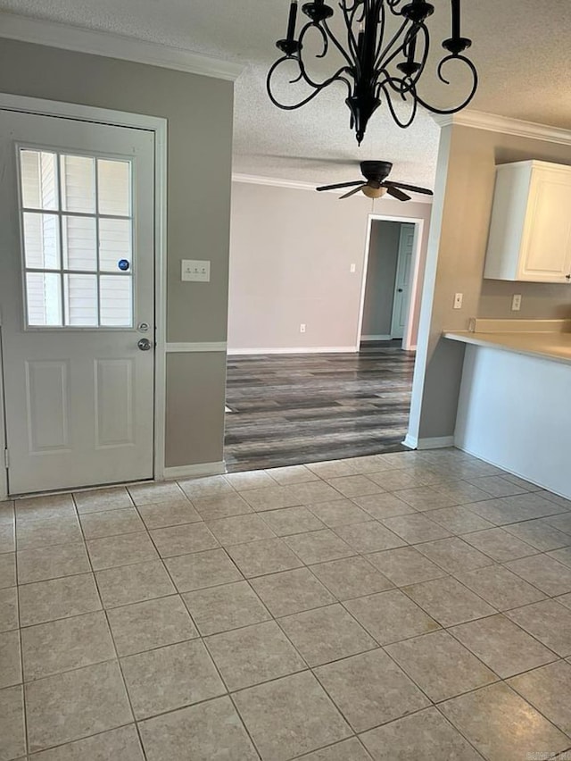 unfurnished dining area featuring a textured ceiling, crown molding, light hardwood / wood-style flooring, and ceiling fan with notable chandelier