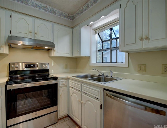 kitchen featuring white cabinetry, sink, stainless steel appliances, a textured ceiling, and light tile patterned flooring