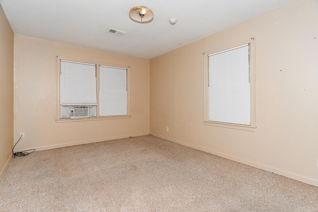 spare room with light carpet and cooling unit