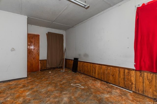 spare room featuring wooden walls