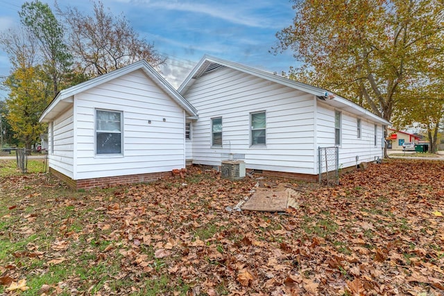 rear view of house featuring central AC