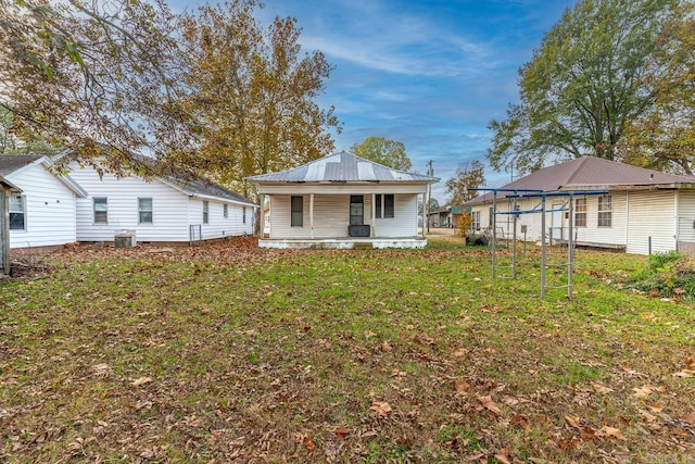 back of house with a lawn, a porch, and cooling unit