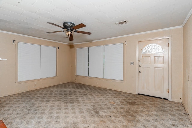 foyer entrance featuring crown molding, ceiling fan, and light carpet