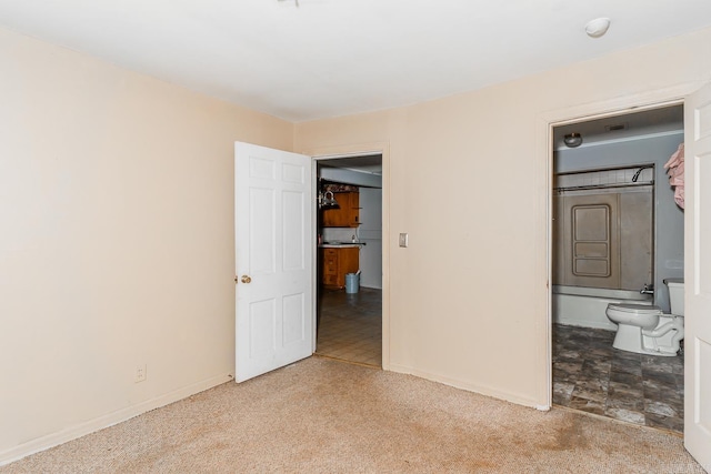 unfurnished bedroom with carpet and ensuite bath