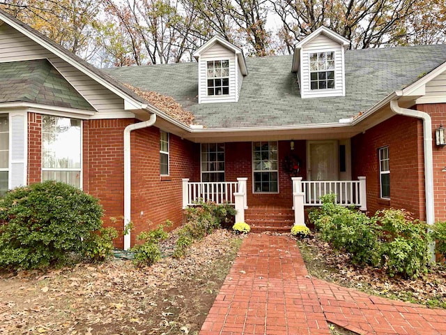 view of exterior entry with covered porch