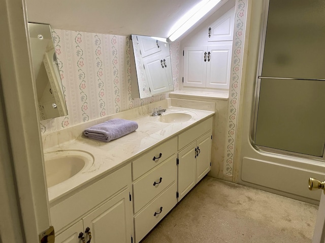 bathroom with vanity and bath / shower combo with glass door